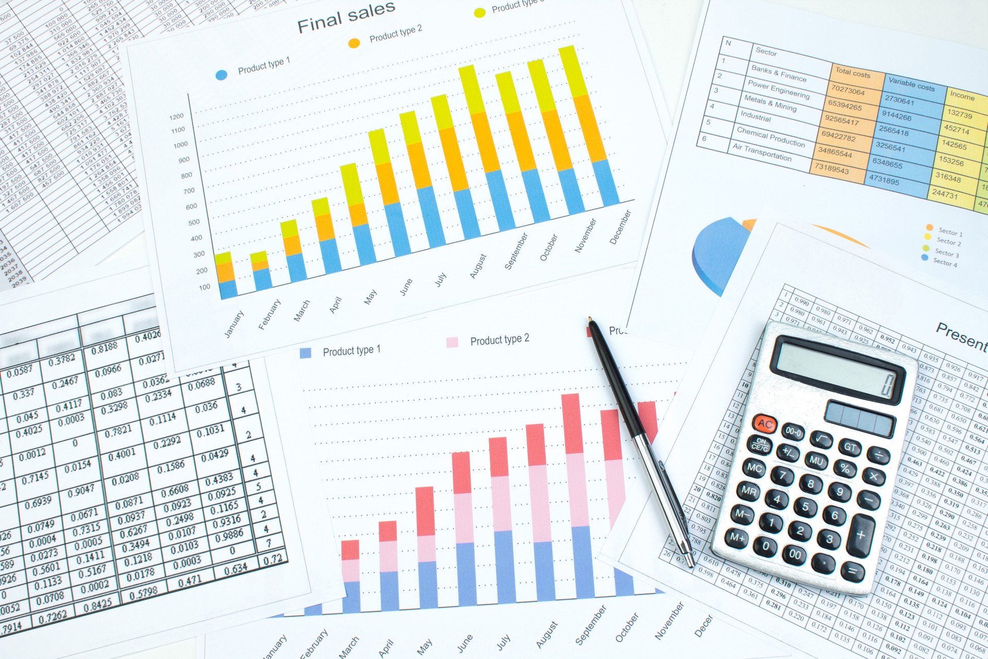 Financial printed paper charts, graphs and diagrams on the table. Top view